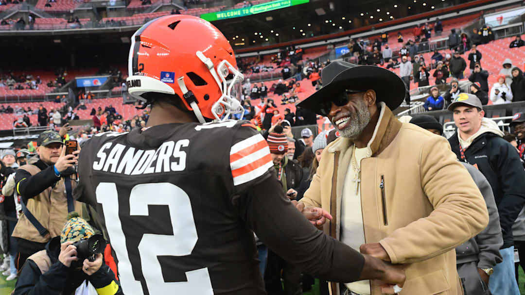 Dec 28, 2025; Cleveland, Ohio, USA; Cleveland Browns quarterback Shedeur Sanders (12) and his father Deion Sanders on the sideline before the game against the Pittsburgh Steelers at Huntington Bank Field. Mandatory Credit: Ken Blaze-Imagn Images