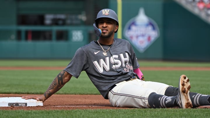 Jun 8, 2024; Washington, District of Columbia, USA; Washington Nationals right fielder Eddie Rosario (8) rests after sliding into third base against the Atlanta Braves during the first inning at Nationals Park.