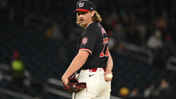 Apr 3, 2024; Washington, District of Columbia, USA; Washington Nationals relief pitcher Hunter Harvey (73) checks a runner at first base against the Pittsburgh Pirates during the seventh inning at Nationals Park. Mandatory Credit: Rafael Suanes-USA TODAY Sports