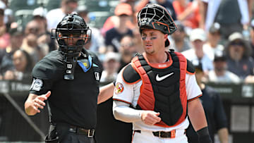Jul 14, 2024; Baltimore, Maryland, USA;  Baltimore Orioles catcher James McCann (27) and umpire Emil Jimenez (82) look towards the dugout during the eighth inning against the New York Yankees at Oriole Park at Camden Yards.