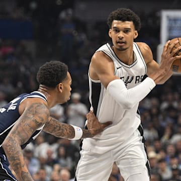 Oct 24, 2024; Dallas, Texas, USA; Dallas Mavericks forward P.J. Washington (25) and San Antonio Spurs center Victor Wembanyama (1) in action during the game between the Dallas Mavericks and the San Antonio Spurs at the American Airlines Center. Mandatory Credit: Jerome Miron-Imagn Images