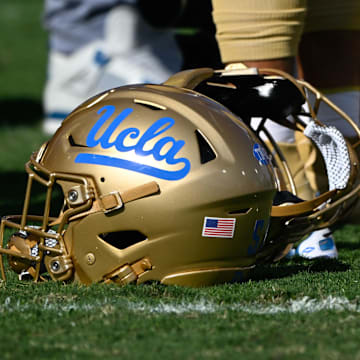 Nov 30, 2024; Pasadena, California, USA; UCLA Bruins helmets during pregame warmups before playing the Fresno State Bulldogs at Rose Bowl. Mandatory Credit: Robert Hanashiro-Imagn Images