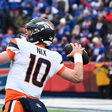 Jan 12, 2025; Orchard Park, New York, USA; Denver Broncos quarterback Bo Nix (10) throws downfield during the first quarter against the Buffalo Bills in an AFC wild card game at Highmark Stadium. Mandatory Credit: Mark Konezny-Imagn Images