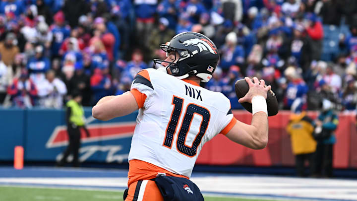 Jan 12, 2025; Orchard Park, New York, USA; Denver Broncos quarterback Bo Nix (10) throws downfield during the first quarter against the Buffalo Bills in an AFC wild card game at Highmark Stadium. Mandatory Credit: Mark Konezny-Imagn Images