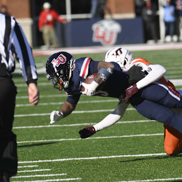 Nov 19, 2022; Lynchburg, Virginia, USA; Liberty Flames wide receiver Demario Douglas (3) catches ball as Virginia Tech Hokies defensive back Mansoor Delane (23) makes tackle at Williams Stadium. Mandatory Credit: Lee Luther Jr.-Imagn Images