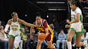 USC’s JuJu Watkins, center, steals the ball from Oregon’s Deja Kelly, left, and Sarah Rambus, right, during the first half at Matthew Knight Arena in Eugene Saturday, Dec. 7, 2024