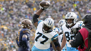 Nov 2, 2025; Green Bay, Wisconsin, USA; Carolina Panthers offensive tackle Yosh Nijman (77) celebrates after a Panthers touchdown during the first half against the Green Bay Packers at Lambeau Field. Mandatory Credit: Jeff Hanisch-Imagn Images