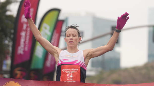 Malindi Elmore wins first place as she crosses the finish line next to Tempe Beach Park at the Arizona half marathon