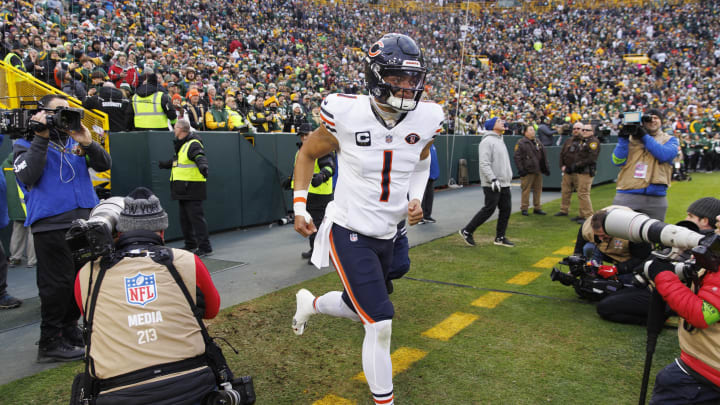 Jan 7, 2024; Green Bay, Wisconsin, USA;  Chicago Bears quarterback Justin Fields (1) runs onto the field ahead of the team's season finale against the Packers.