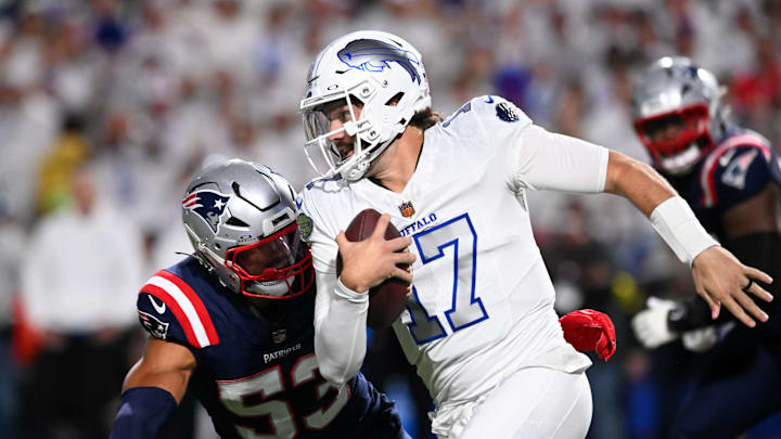 Bills quarterback Josh Allen (17) rushes the ball against the Patriots Sunday night. Bills quarterback Josh Allen (17) rushes the ball against the Patriots Sunday night.