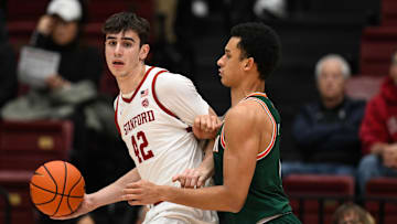 Jan 22, 2025; Stanford, California, USA; Stanford Cardinal forward Maxime Raynaud (42) dribbles against Miami (FL) Hurricanes center Lynn Kidd (1) in the first half at Maples Pavilion. Mandatory Credit: Eakin Howard-Imagn Images
