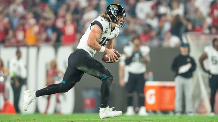 Dec 24, 2023; Tampa, Florida, USA; Jacksonville Jaguars quarterback Trevor Lawrence (16) runs the ball against the Tampa Bay Buccaneers in the third quarter at Raymond James Stadium. Mandatory Credit: Jeremy Reper-USA TODAY Sports