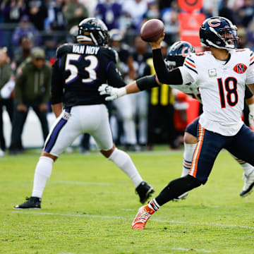 Caleb Williams gets a pass off under pressure in Sunday's loss at Baltimore.