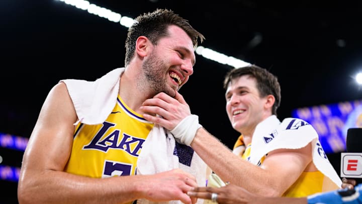 Los Angeles Lakers guard Luka Doncic (77) reacts with guard Austin Reaves (15) 
