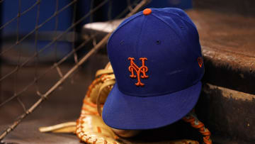Aug 5, 2021; Miami, Florida, USA; A detailed view of the cap and mitt of New York Mets first baseman Pete Alonso (not pictured) on the dugout steps prior the the game against the Miami Marlins at loanDepot park. Mandatory Credit: Jasen Vinlove-USA TODAY Sports
