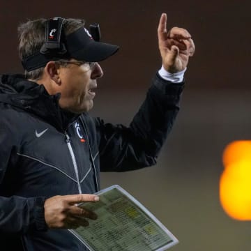 Cincinnati Bearcats head coach Scott Satterfield attempts to call a play following a touchdown in the fourth quarter of the NCAA Big12 football game between the Oklahoma State Cowboys and the Cincinnati Bearcats at Boone Pickens Stadium in Stillwater, Okla., on Saturday, Oct. 28, 2023.