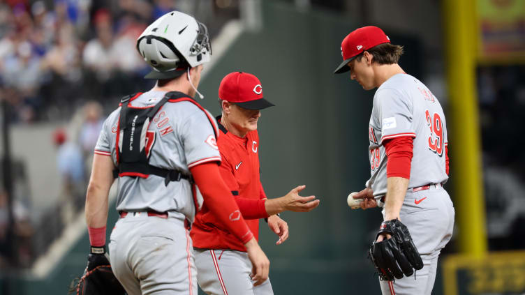 Apr 26, 2024; Arlington, Texas, USA;  Cincinnati Reds manager David Bell (25) takes the ball from Lucas Sims