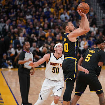  Golden State Warriors guard Stephen Curry (30) makes a three point shot over Denver Nuggets center Nikola Jokic (15) in the third quarter during game five of the first round for the 2022 NBA playoffs at Chase Center. Mandatory Credit: Cary Edmondson-Imagn Images