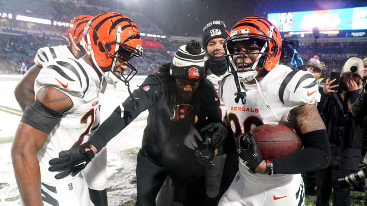 Cincinnati Bengals cornerback Cam Taylor-Britt (29), right, is embraced and congratulated by