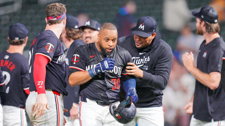 Jun 18, 2024; Minneapolis, Minnesota, USA; Minnesota Twins first base Carlos Santana (30) celebrates his game winning hit with pitcher Jhoan Duran (59) against the Tampa Bay Rays in the ninth inning at Target Field. Mandatory Credit: Brad Rempel-USA TODAY Sports