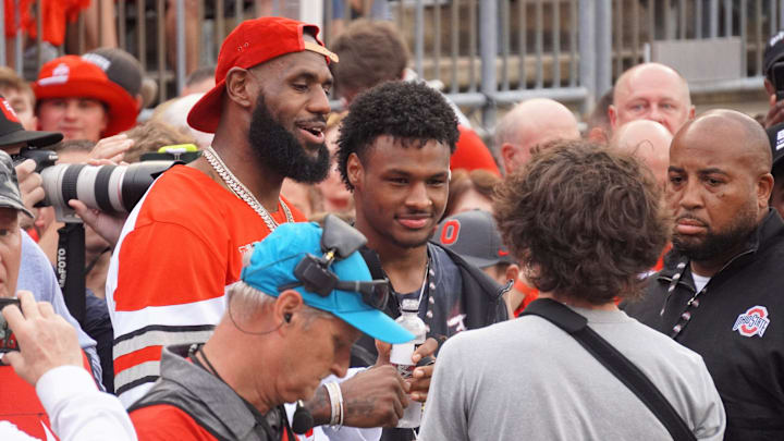 LeBron James and Bronny James look on before a football game between the Ohio State Buckeyes and Notre Dame Fighting Irish LeBron James and Bronny James look on before a football game between the Ohio State Buckeyes and Notre Dame Fighting Irish