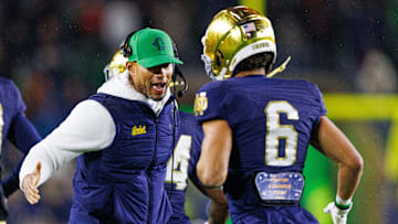 Notre Dame head coach Marcus Freeman, left, celebrates with wide receiver Jordan Faison (6) after a touchdown during the first half of a NCAA football game against Navy at Notre Dame Stadium on Saturday, Nov. 8, 2025, in South Bend.