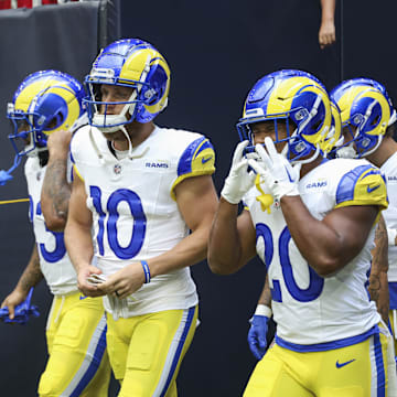 Aug 24, 2024; Houston, Texas, USA; Los Angeles Rams wide receiver Cooper Kupp (10) and running back Ronnie Rivers (20) walk onto the field before the game against the Houston Texans at NRG Stadium. Mandatory Credit: Troy Taormina-Imagn Images