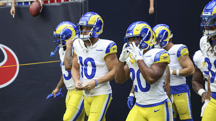 Aug 24, 2024; Houston, Texas, USA; Los Angeles Rams wide receiver Cooper Kupp (10) and running back Ronnie Rivers (20) walk onto the field before the game against the Houston Texans at NRG Stadium. Mandatory Credit: Troy Taormina-Imagn Images