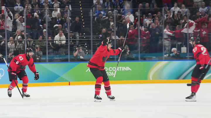 Feb 20, 2026; Milan, Italy; Travis Sanheim (6) of Canada celebrates a goal scored by Shea Theodore (27) of Canada during the third period against Finland in a men's ice hockey semifinal during the Milano Cortina 2026 Olympic Winter Games at Milano Santagiulia Ice Hockey Arena.