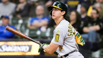 Apr 18, 2025; Milwaukee, Wisconsin, USA;  Athletics first baseman Tyler Soderstrom (21) singles during the first inning against the Milwaukee Brewers at American Family Field. Mandatory Credit: Jeff Hanisch-Imagn Images