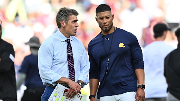 Aug 31, 2024; College Station, Texas, USA; Chris Fowler a broadcaster for ESPN, left, speaks with Notre Dame Fighting Irish head coach Marcus Freeman prior to the game against the Texas A&M Aggies at Kyle Field. Mandatory Credit: Maria Lysaker-Imagn Images