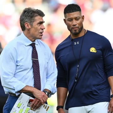 Aug 31, 2024; College Station, Texas, USA; Chris Fowler a broadcaster for ESPN, left, speaks with Notre Dame Fighting Irish head coach Marcus Freeman prior to the game against the Texas A&M Aggies at Kyle Field. Mandatory Credit: Maria Lysaker-USA TODAY Sports