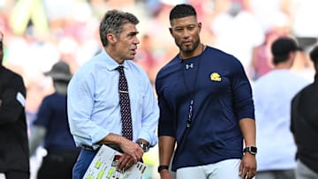 Aug 31, 2024; College Station, Texas, USA; Chris Fowler a broadcaster for ESPN, left, speaks with Notre Dame Fighting Irish head coach Marcus Freeman prior to the game against the Texas A&M Aggies at Kyle Field. Mandatory Credit: Maria Lysaker-Imagn Images