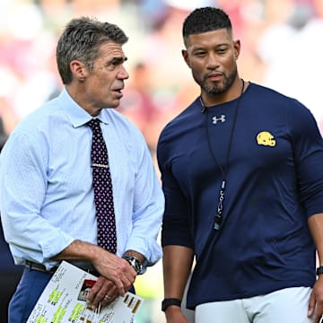 Aug 31, 2024; College Station, Texas, USA; Chris Fowler a broadcaster for ESPN, left, speaks with Notre Dame Fighting Irish head coach Marcus Freeman prior to the game against the Texas A&M Aggies at Kyle Field. Mandatory Credit: Maria Lysaker-Imagn Images