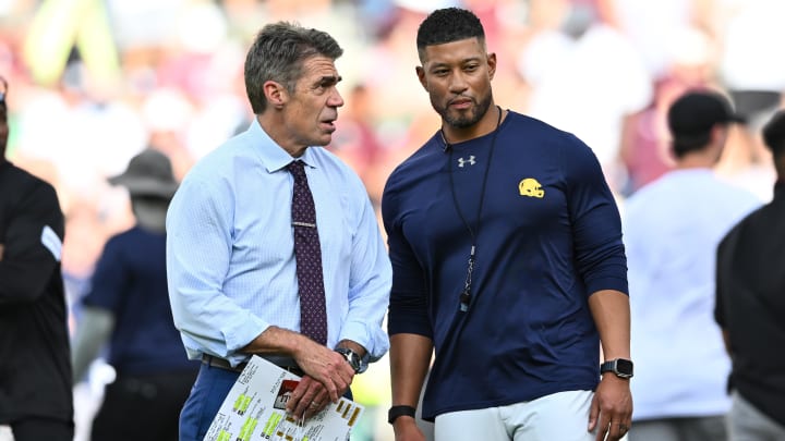 Aug 31, 2024; College Station, Texas, USA; Chris Fowler a broadcaster for ESPN, left, speaks with Notre Dame Fighting Irish head coach Marcus Freeman prior to the game against the Texas A&M Aggies at Kyle Field. 