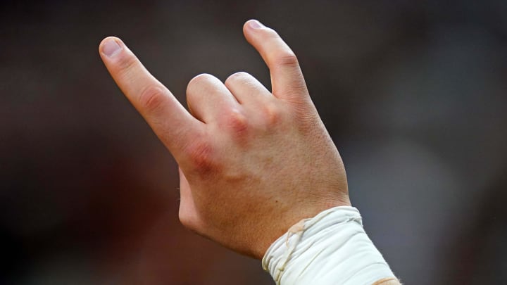 Jan 1, 2024; New Orleans, LA, USA; A Texas Longhorns fan shows the hook'em horns sign.