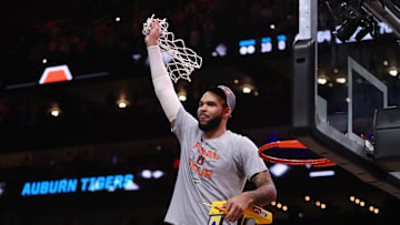 Mar 30, 2025; Atlanta, GA, USA; Auburn Tigers forward Johni Broome (4) cuts down the net after winning the South Regional final of the 2025 NCAA tournament against the Michigan State Spartans at State Farm Arena. Mandatory Credit: Brett Davis-Imagn Images