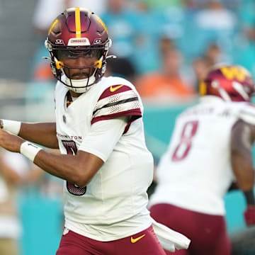 Aug 17, 2024; Miami Gardens, Florida, USA;  Washington Commanders quarterback Jayden Daniels (5) drops back to pass against the Miami Dolphins during the first quarter at Hard Rock Stadium. Mandatory Credit: Jim Rassol-Imagn Images