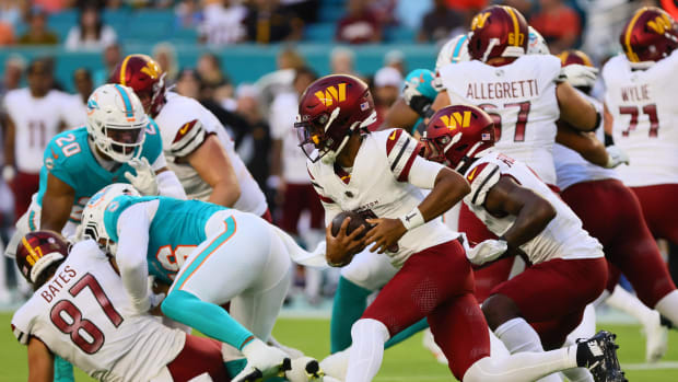 Aug 17, 2024; Miami Gardens, Florida, USA; Washington Commanders quarterback Jayden Daniels (5) runs with the football agains