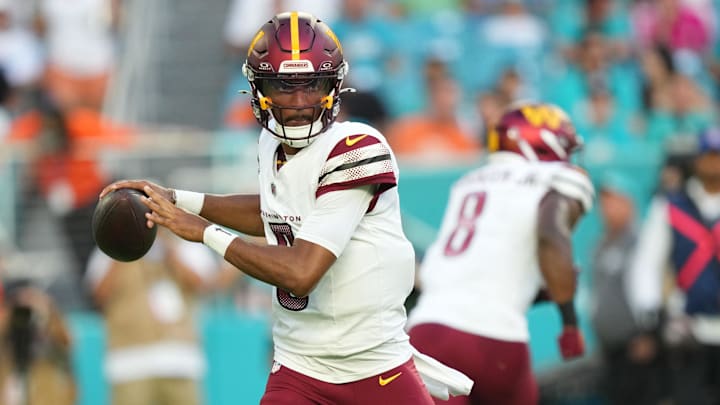 Aug 17, 2024; Miami Gardens, Florida, USA;  Washington Commanders quarterback Jayden Daniels (5) drops back to pass against the Miami Dolphins during the first quarter at Hard Rock Stadium. Mandatory Credit: Jim Rassol-Imagn Images