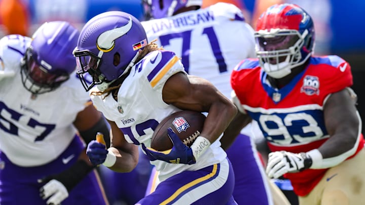 Sep 8, 2024; East Rutherford, New Jersey, USA; Minnesota Vikings running back Aaron Jones (33) carries the ball as New York Giants defensive tackle Rakeem Nunez-Roches (93) pursues during the first half at MetLife Stadium.