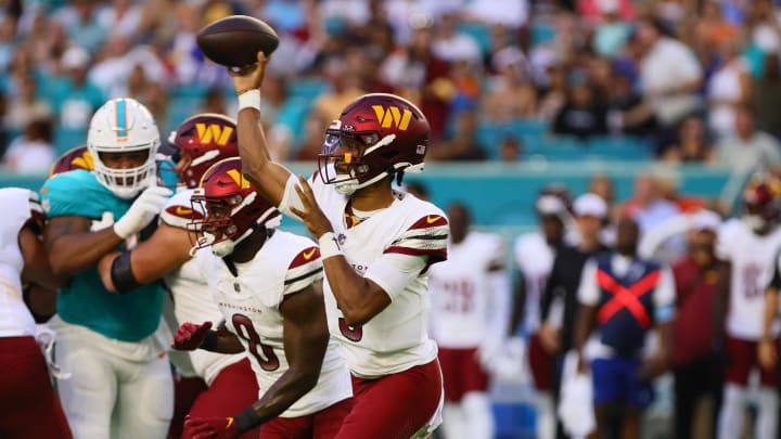 Aug 17, 2024; Miami Gardens, Florida, USA; Washington Commanders quarterback Jayden Daniels (5) throws the football against the Miami Dolphins during the first quarter of a preseason game at Hard Rock Stadium. Mandatory Credit: Sam Navarro-USA TODAY Sports