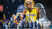 Jan 26, 2021; Los Angeles, California, USA; Fans gather at a mural of Kobe Bryant and his daughter Gianna painted on the wall of Hardcore Fitness Bootcamp gym in downtown Los Angeles. Bryant and his daughter and seven other persons died in a helicopter crash in Calabasas, Calif. on Jan. 26, 2020. Mandatory Credit: Robert Hanashiro-Imagn Images