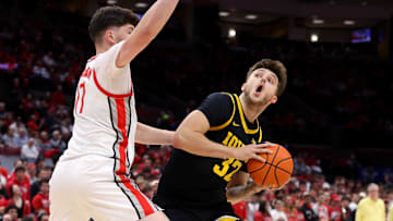 Jan 27, 2025; Columbus, Ohio, USA;  Iowa Hawkeyes forward Owen Freeman (32) looks to score as Ohio State Buckeyes center Ivan Njegovan (17) defends during the first half at Value City Arena. Mandatory Credit: Joseph Maiorana-Imagn Images