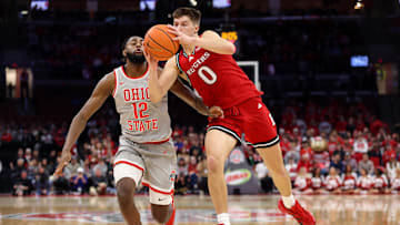 Dec 7, 2024; Columbus, Ohio, USA;  Rutgers Scarlet Knights guard Jordan Derkack (0) grabs the ball as Ohio State Buckeyes guard Evan Mahaffey (12) defends during the first half at Value City Arena. Mandatory Credit: Joseph Maiorana-Imagn Images