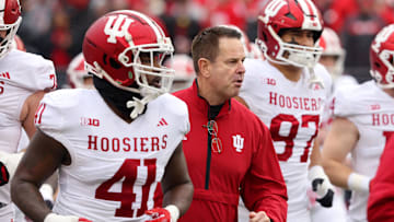 Nov 23, 2024; Columbus, Ohio, USA;  Indiana Hoosiers head coach Curt Cignetti runs with his team before the game against the Ohio State Buckeyes at Ohio Stadium. Mandatory Credit: Joseph Maiorana-Imagn Images
