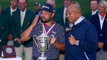J.J. Spaun celebrates with the U.S. Open trophy as he talks with NBC Sports broadcaster Mike Tirico after winning in June.