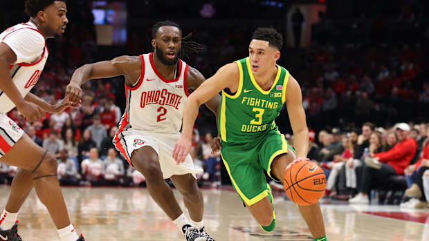 Oregon Ducks guard Jackson Shelstad (3) dribbles the ball past Ohio State Buckeyes guard Bruce Thornton (2) 