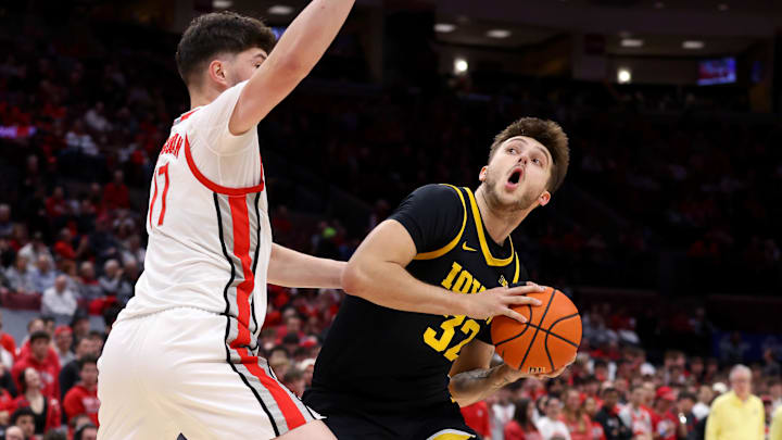 Jan 27, 2025; Columbus, Ohio, USA;  Iowa Hawkeyes forward Owen Freeman (32) looks to score as Ohio State Buckeyes center Ivan Njegovan (17) defends during the first half at Value City Arena. Mandatory Credit: Joseph Maiorana-Imagn Images
