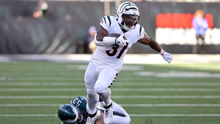 Oct 27, 2024; Cincinnati, Ohio, USA;  Cincinnati Bengals running back Zack Moss (31) runs the ball as Philadelphia Eagles linebacker Zack Baun (53) defends during the third quarter at Paycor Stadium. Mandatory Credit: Joseph Maiorana-Imagn Images